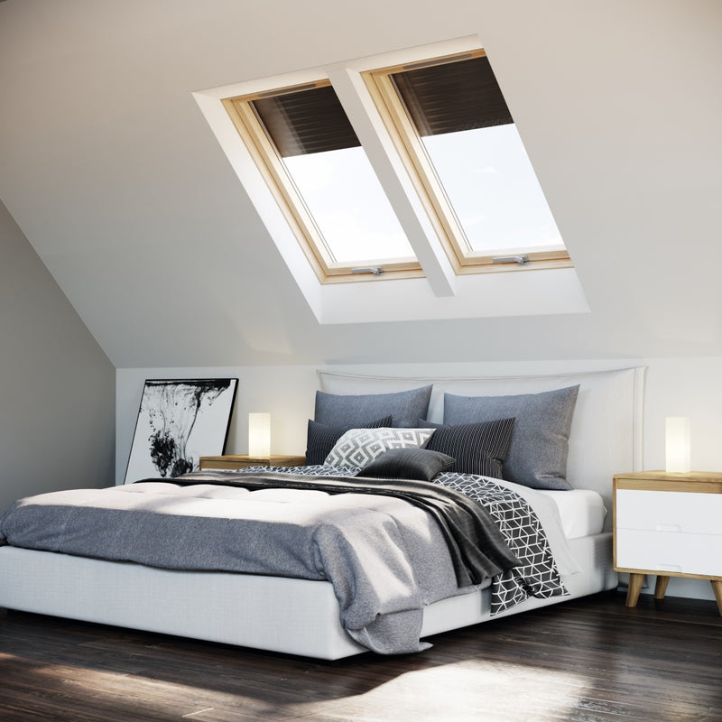 An image of a Dakea Better Energy Centre Pivot Roof Window with a Pine finish KAV B1500 installed above a bedroom to show how they look.