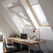 An image of a Dakea Better Energy Centre Pivot Roof Window with a Pine finish KAV B1500 installed above an office space to show how they look.