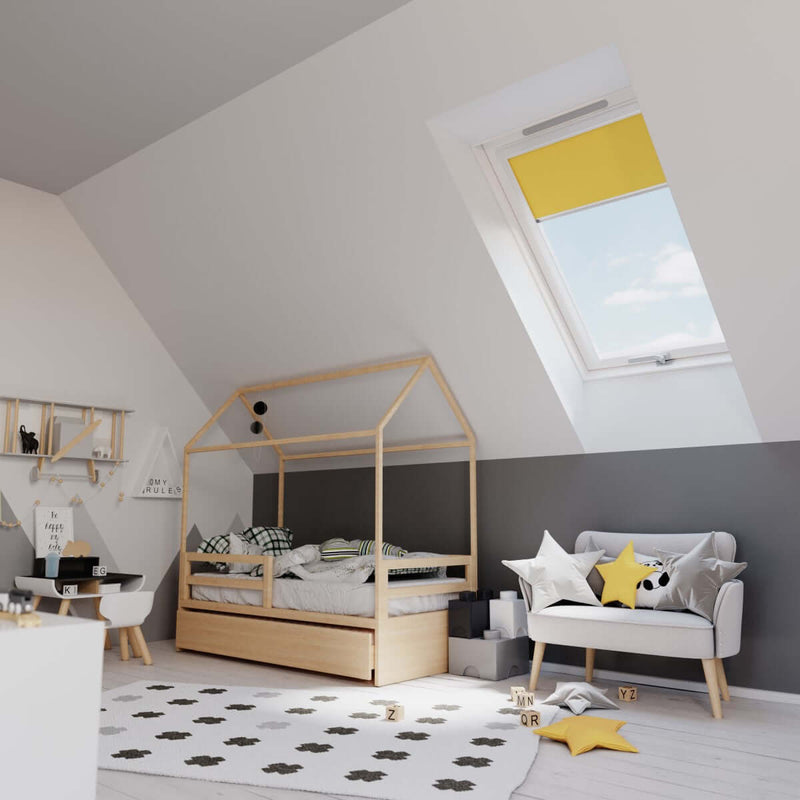 An image showing a Dakea Better Safe Centre Pivot Roof Window fitted into a bedroom with a yellow blind to show what it can look like.