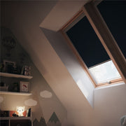 An image showing a Dakea window with a dark blue coloured blackout blind 4212 in a bedroom