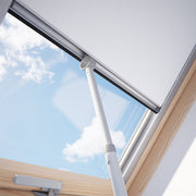 An image of a Dakea Telescopic Opening Rod ZCA being used to open a blind to show how it can be used.