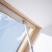 An image of a Dakea Telescopic Opening Rod ZCA being used to open a vent on a window to show how it can be used.