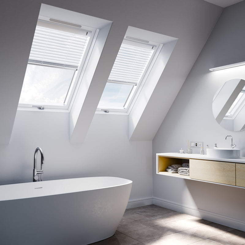 An image showing a Dakea Ultima Energy Centre Pivot Roof Window PVC-KEP-B1800 fitted into a livingroom to show how it looks