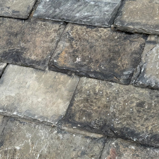 An image showing Delabole Cornish Reclaimed Diminishing Slate laid out in a similar way they would go on a roof.