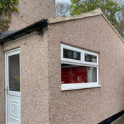 An image of a house with Derbyshire Spar Dashing Stone applied to the render on the walls of the property.