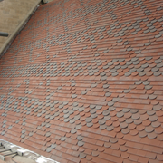 An image showing a roof of Dreadnought Clay Tiles with Bullnose details, they are Smooth Red / Blue Blend in colour