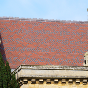 An image showing a roof of Dreadnought Clay Tiles with Bullnose details, they are Smooth Red / Blue Blend in colour