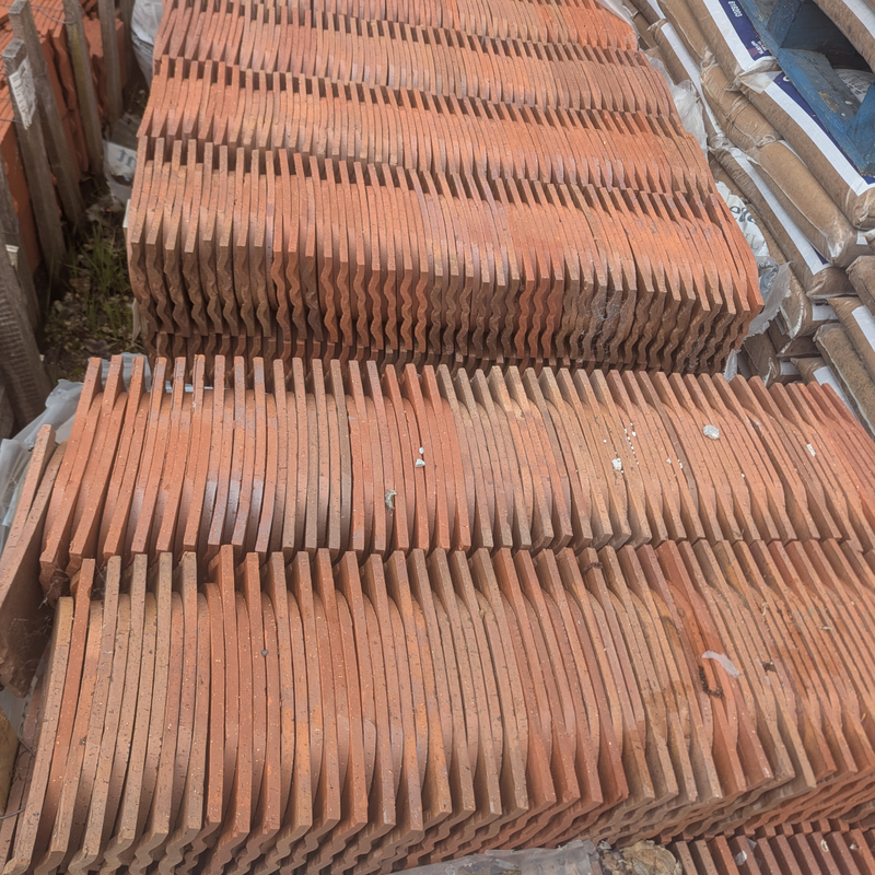 An image showing a pallet of Dreadnought Clay Bullnose Tiles in Smooth Red Blue Blend.