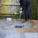 An image of easy joint paving jointing compound being brushed into the paving joints.