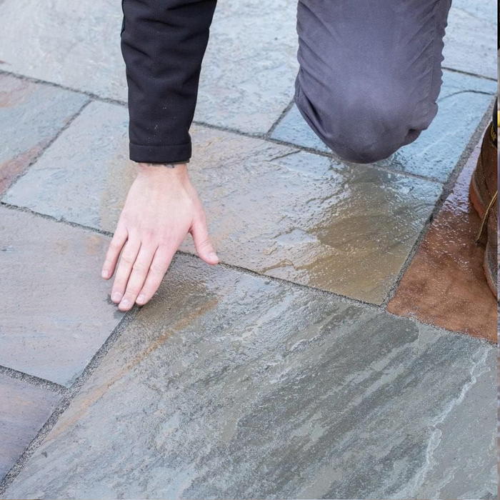 An image of easy joint paving jointing compound being finished by running a finger over it to get the required look.