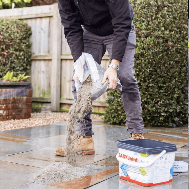 An image of easy joint paving jointing compound being poured onto a patio ready for laying.