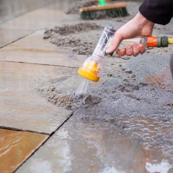 An image of easy joint paving jointing compound being prepared by spraying it with water,