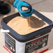Image of the contents in a tub of Azpects EasyJoint Porcelain Next-Gen Jointing Paving Compound. It is a sand-like texture.