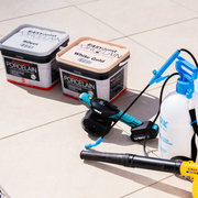 Image of both colours of Azpects EasyJoint Porcelain Next-Gen Jointing Paving Compound which are White gold and Silver, it also has some helpful tools next to it that would help including a compactor and a water sprayer.