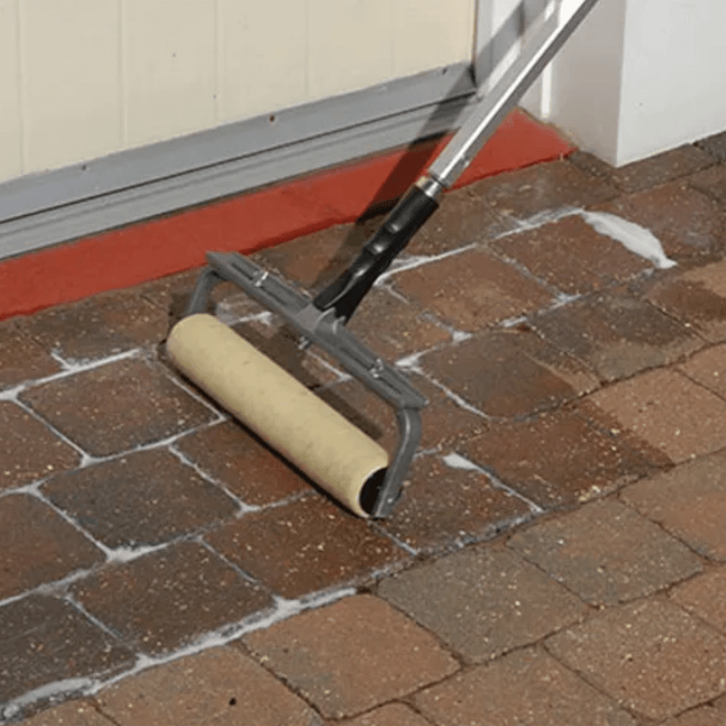 an image of EASYSeal BCS Block and Concrete Sealer being applied with a long armed roller to block paving