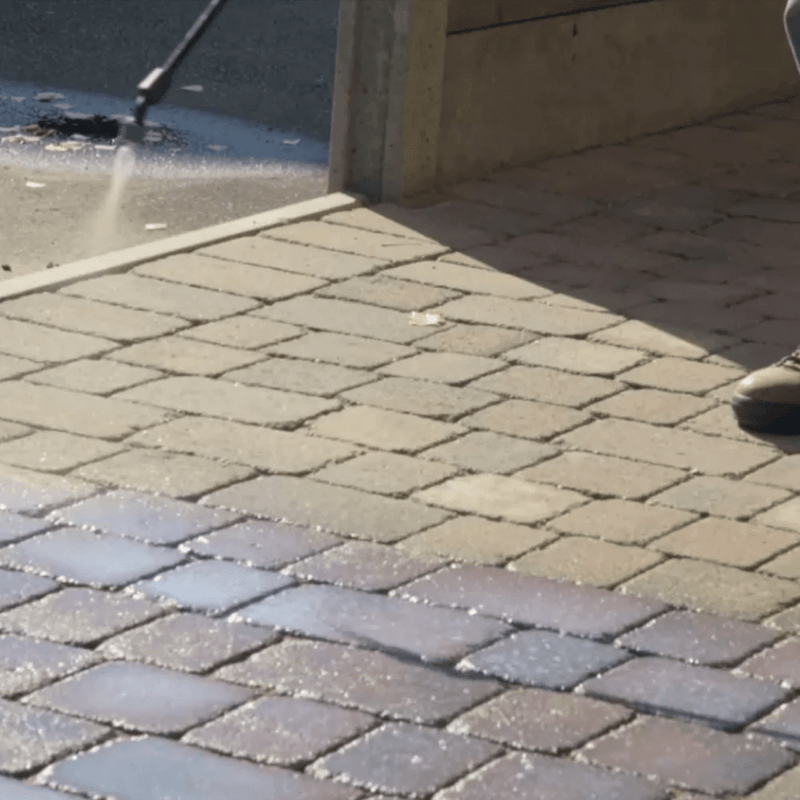 An image of Azpects EASYSeal Contract 20 Litres Block & Concrete Sealer being sprayed onto Block paving