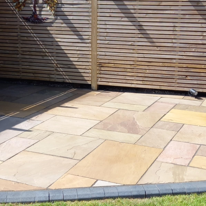 An image of EasySeal Sandstone Sealer & Enhancer that has been applied to a patio to show the effect. It makes the stone colour deeper and shows off the tones in the colour tones on the slabs.