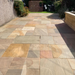 An image of EasySeal Sandstone Sealer & Enhancer that has been applied to a patio to show the effect. It makes the stone colour deeper and shows off the tones in the colour tones on the slabs.