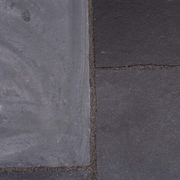 An image of some paving slabs with Azpects Slate & Limestone Enhancer and sealer having been used on half of it to show the difference. The right hand side that it has been used on looks less faded and darker / fresher.