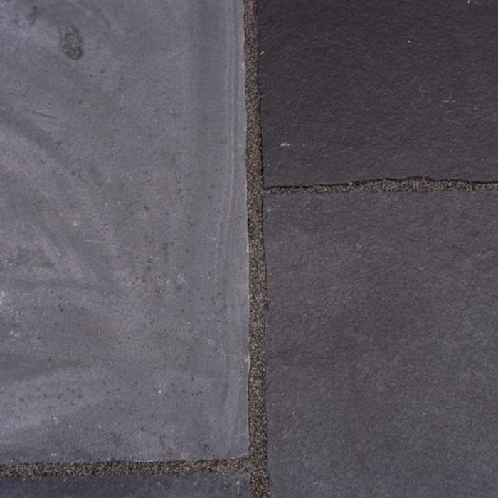 An image of some paving slabs with Azpects Slate & Limestone Enhancer and sealer having been used on half of it to show the difference. The right hand side that it has been used on looks less faded and darker / fresher.