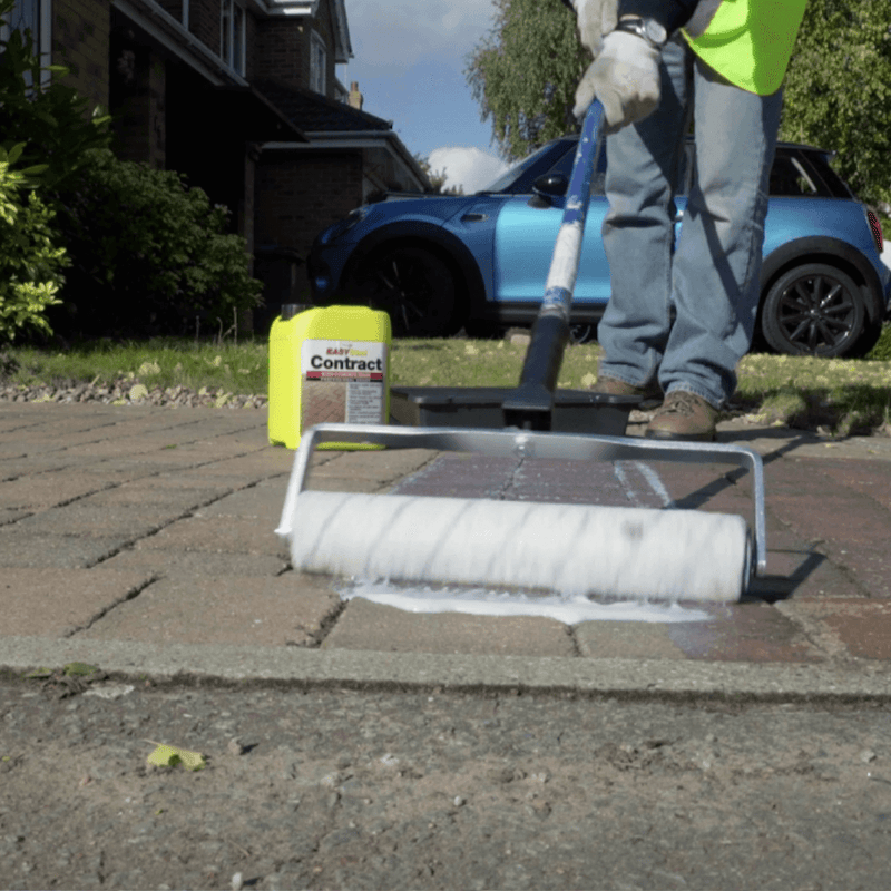 An image of a azpects easyseal contract block and concrete sealer being rolled on by a long armed roller.