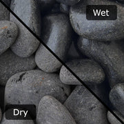 An image showing Ebony Cobble Stone Aggregate Gravel. The image is split horizontally to sow the difference between wet and dry.