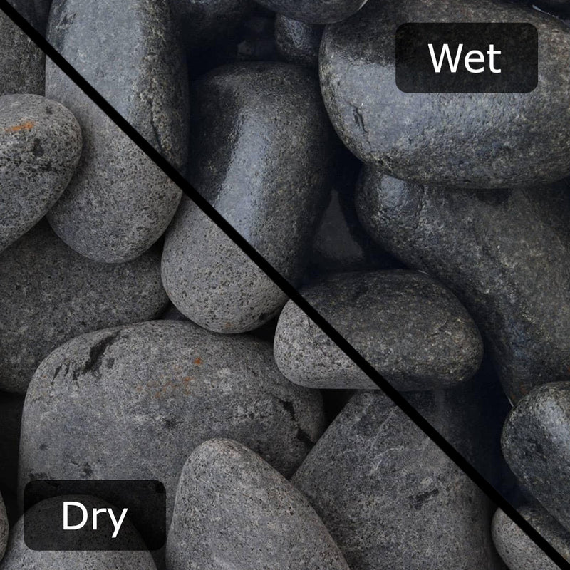 An image showing Ebony Cobble Stone Aggregate Gravel. The image is split horizontally to sow the difference between wet and dry.