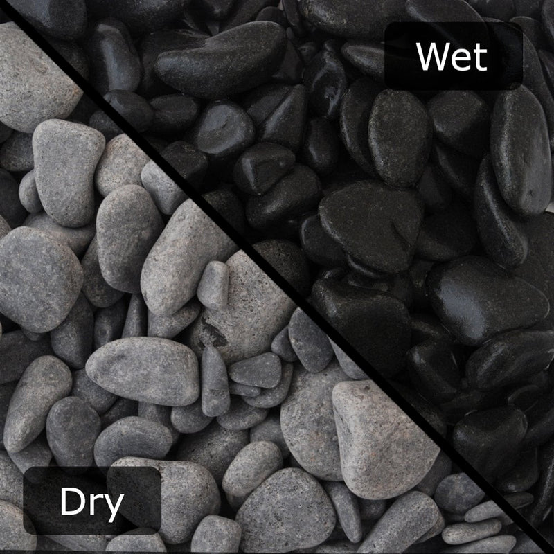 An image showing Ebony Pebble Stone Aggregate Gravel. The image is split horizontally to sow the difference between wet and dry.