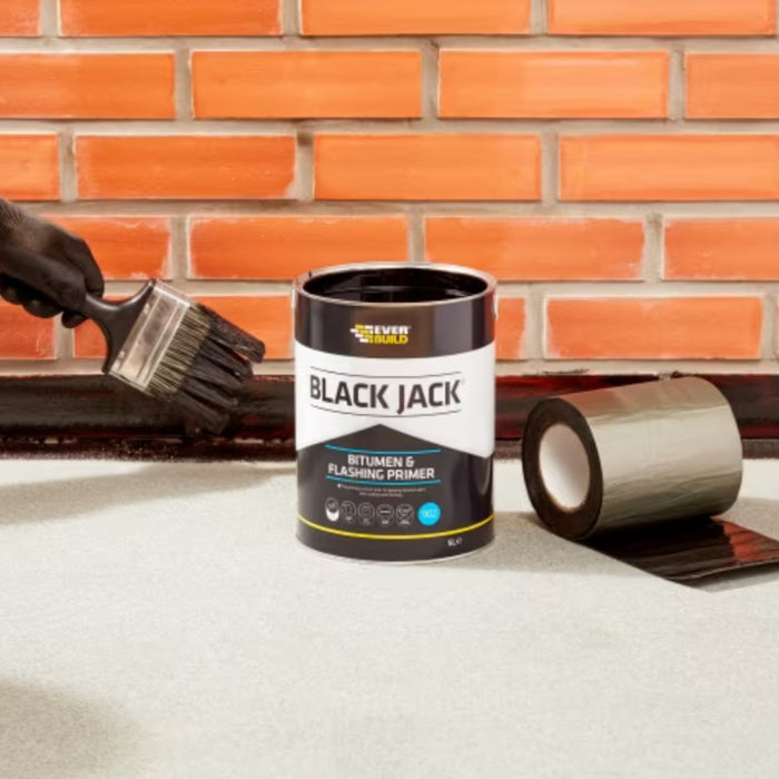 An Image of Everbuild Black Jack Bitumen & Flashing Primer 902 being painted onto the edge of a wall ready for flashing.