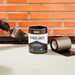 An Image of Everbuild Black Jack Bitumen & Flashing Primer 902 being painted onto the edge of a wall ready for flashing.