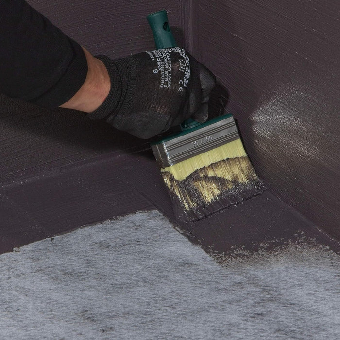 An image of Black Jack DPM 908 being applied to a corner surface with a brush.