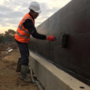 An image of Black Jack DPM 908 being applied to a wall with a roller.