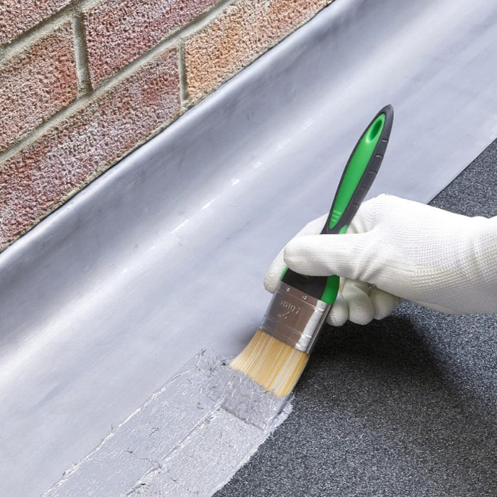 An image of Everbuild Evercryl One Coat Roof Repair being applied with a brush to bridge a roof gap to prevent leaks.