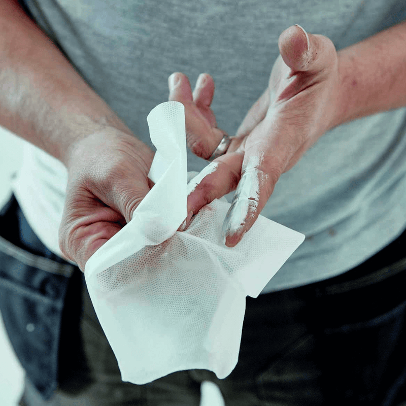 An image of someone using Everbuild Multi-Use Wonder Wipes to clean paint off of their hands.