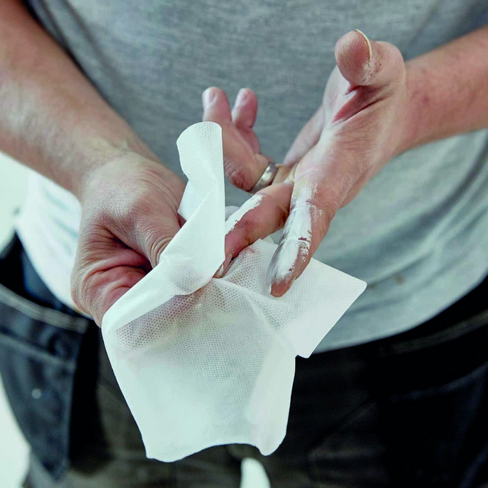 An image of someone using Everbuild Multi-Use Wonder Wipes to clean paint off of their hands.