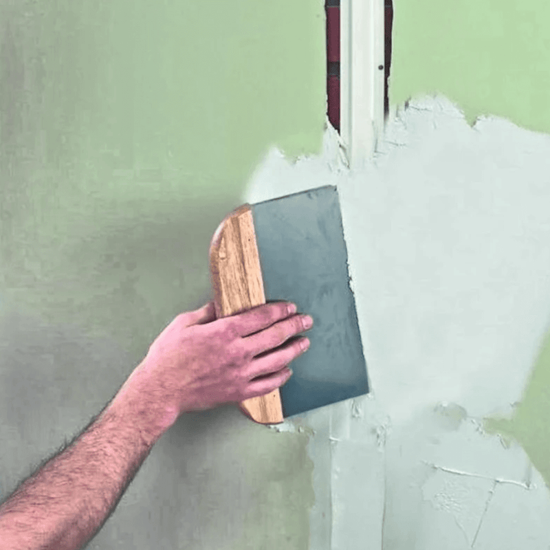 An image of Everbuild Fill and Skim being used to fill an uneven wall.