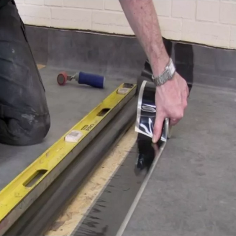 An image of FlexiProof Uncured Flashing Tape that is being applied to fasten down some rubber.