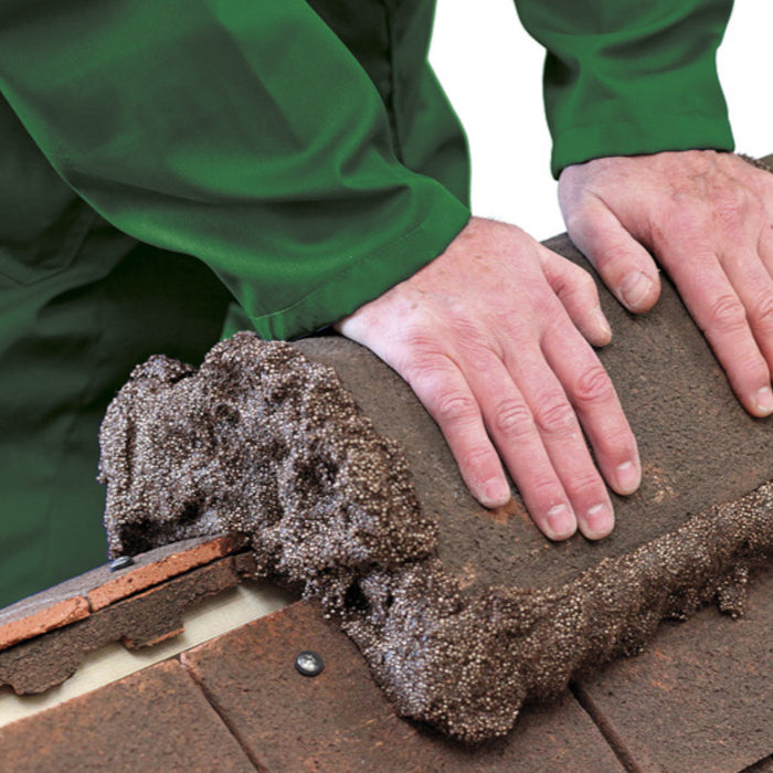 A an image of Flexim Roof Putty being used around a ridge tile to fix it to a roof.