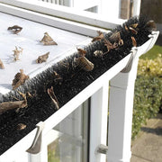 An image of a fully installed Gutter Brush Guard System and how it keeps leaves out of a gutter