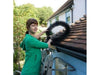 A woman installing a gutter brush