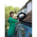 A woman installing a gutter brush