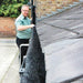 A man installing a gutter brush