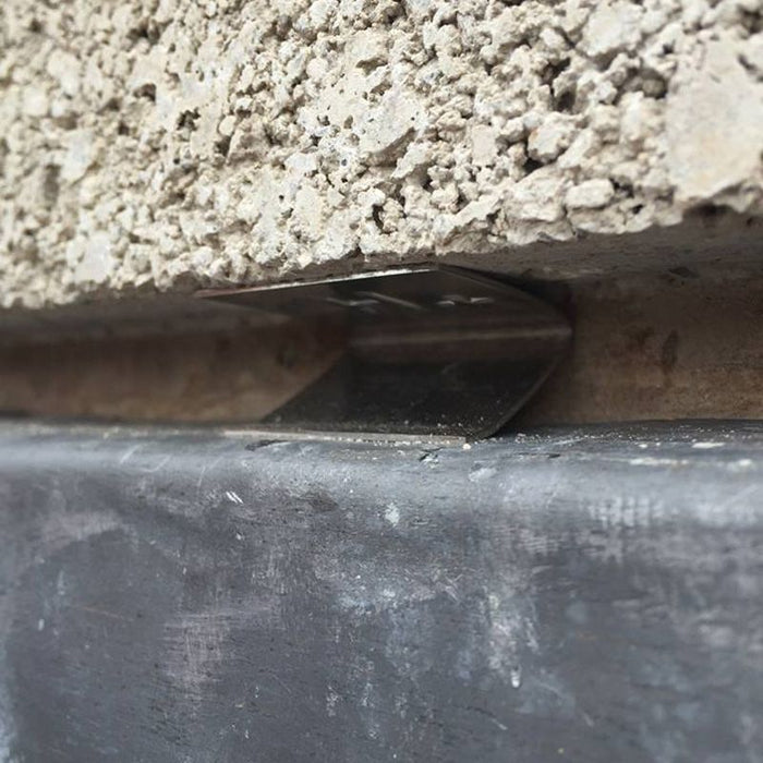 An image of an EasyTrim  Hall Clip / Lead Fixing Clip being used to fix lead flashing to brick.