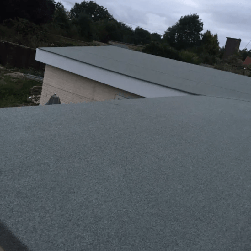 An image of a shed roof covered with IKO EASYSEAL Self Adhesive Cap Sheet in Green to show what it would look like.