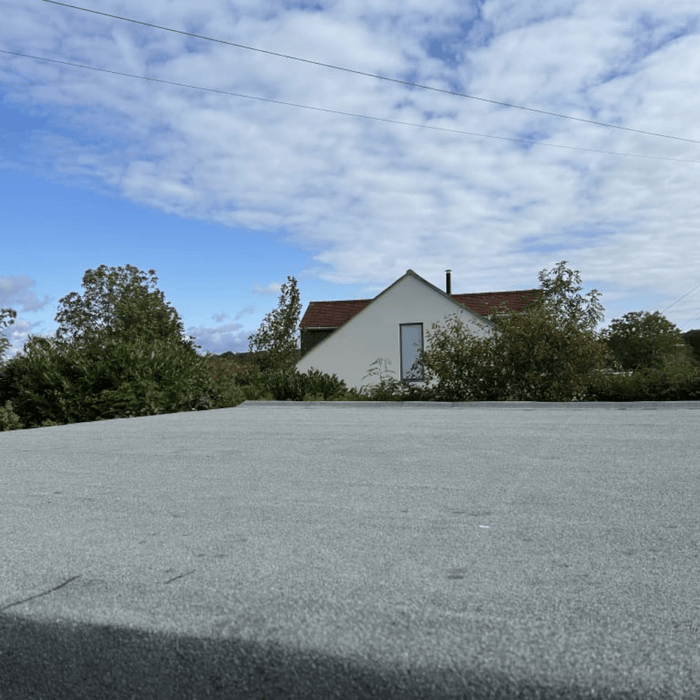 An image of a shed roof covered with IKO EASYSEAL Self Adhesive Cap Sheet in Green to show what it would look like.