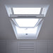 An image showing a close up of a Dakea Secure White Centre Pivot Roof Window in white KAQ B1010Q and the locking mechanism 