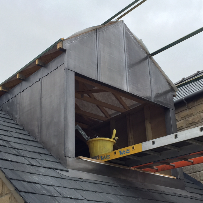 An image of a dormer covered with Code 5 Lead.