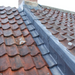 An image of a pitched roof with Lead Soakers over the roofing slates made from Code 3.