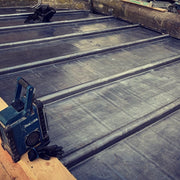 An image showing a lead roof fitted around Wooden Roll Mops that are 50mm wide for a decorative finish