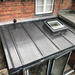 An image of a conservatory roof covered with Code 5 Lead. It is formed around a skylight and also a vent.